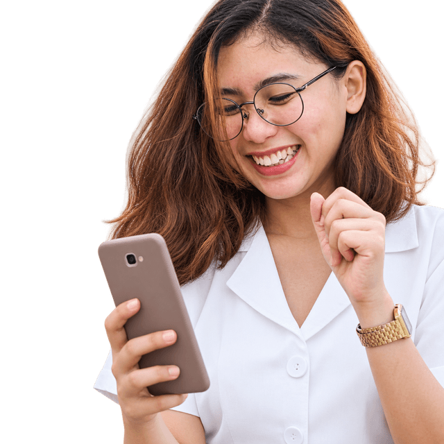 A woman smiling while using her phone